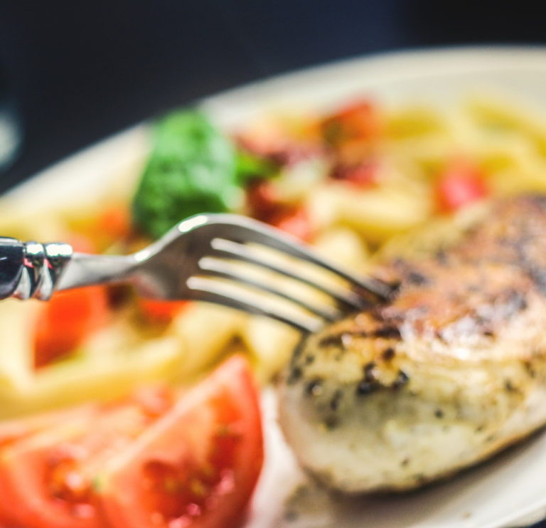 Image of a fork in a piece of meat.