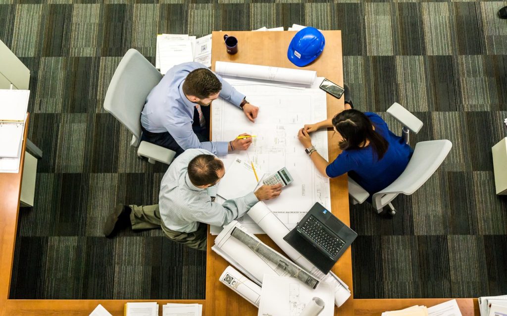 meeting with three people on a desk