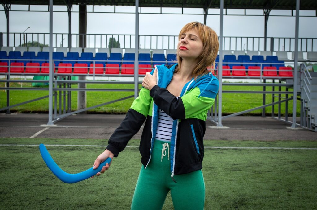 Photo of a woman holding her shoulder due to an injury