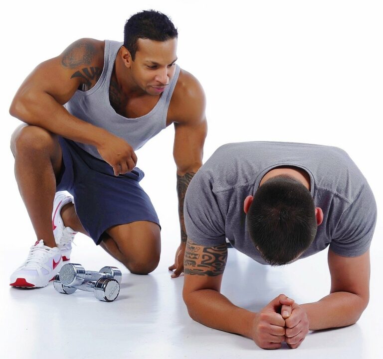 A personal trainer and his client doing plank for abs.